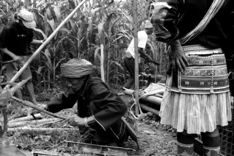 akha men and woman prepare the campsite for ritual