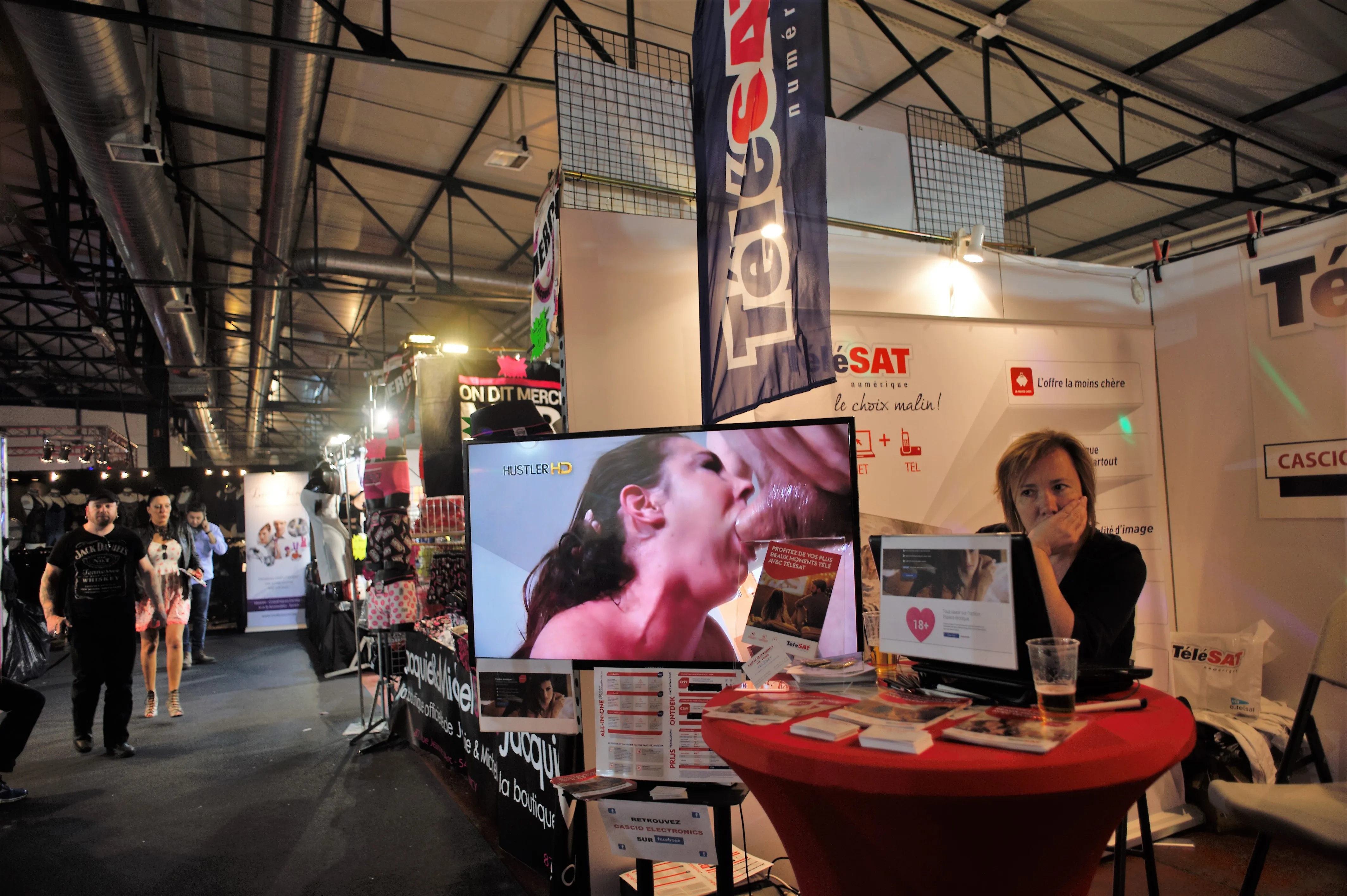 woman at the desk next to porn movie display
