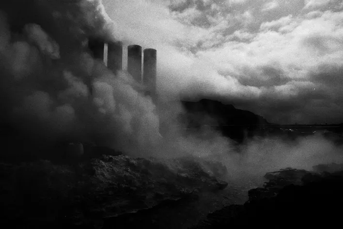 factory pipes behind the smoke