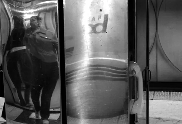 people reflection in metal distorted