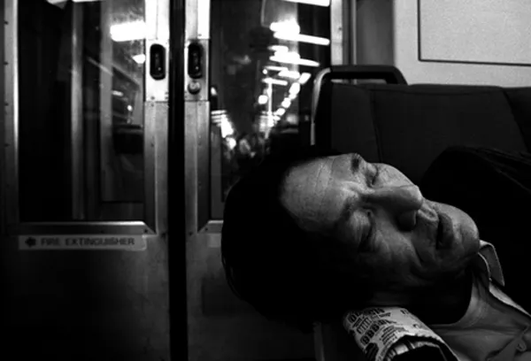 man sleeping on a train