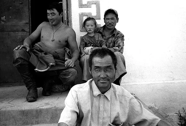 mongolian family sitting on the street