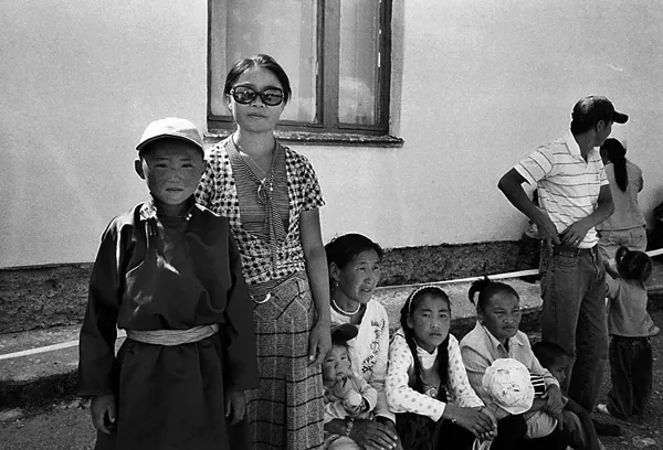 queing mongolians in front of building