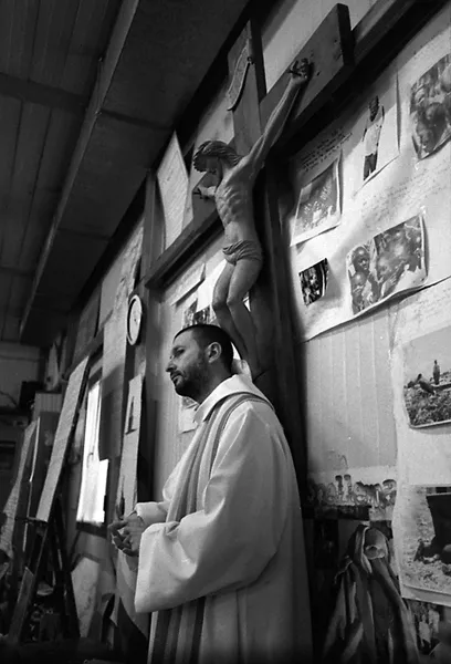 don santoro priest under cross in le piagge celebrates mass