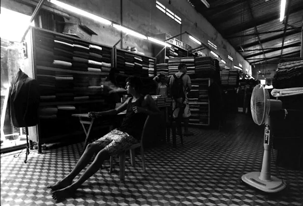 tourist smokes a sigarette while dress is being made